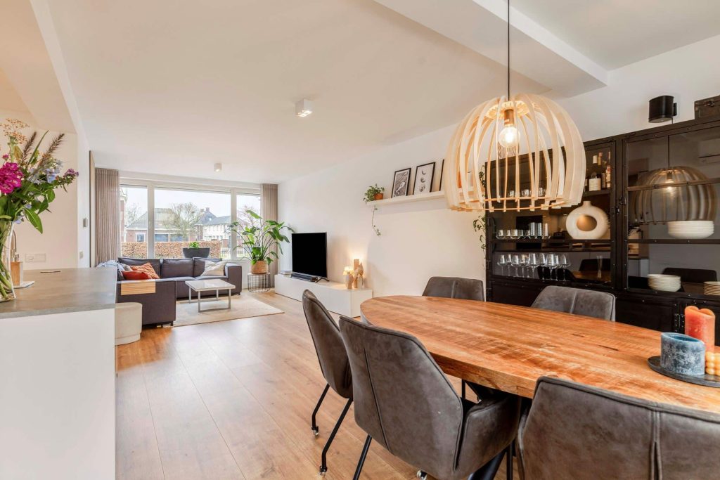 Modern living room with wooden dining table and chair.