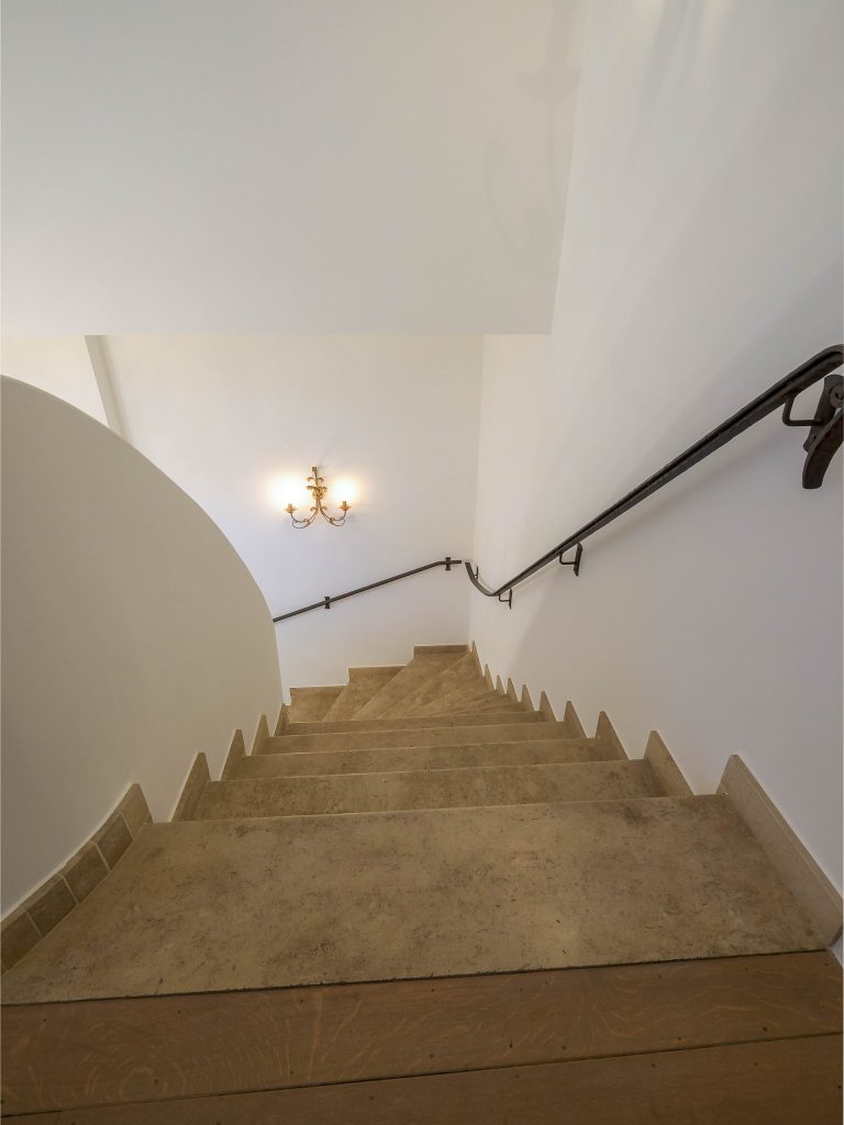 Trap met beige treden en smeedijzeren leuning