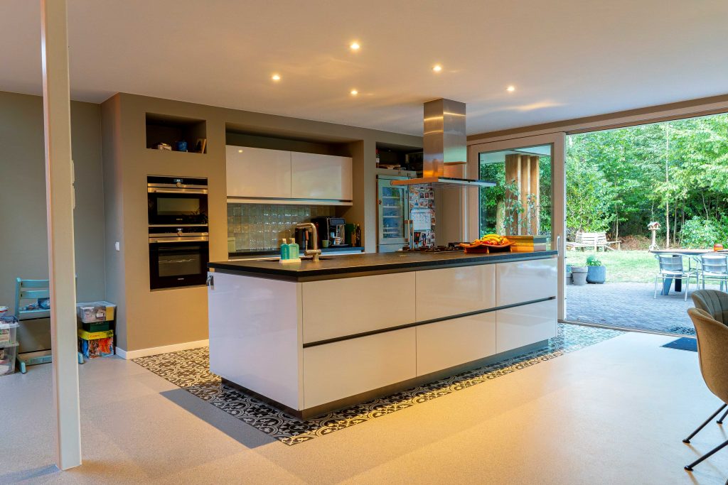 Modern kitchen with island and garden views.