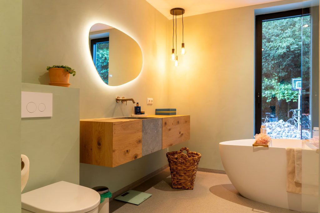 Modern bathroom with bath, washbasin and large window
