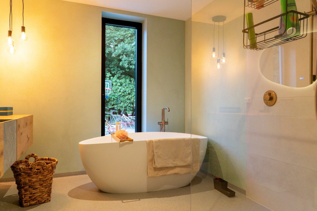 Modern bathroom with separate bathtub and window.