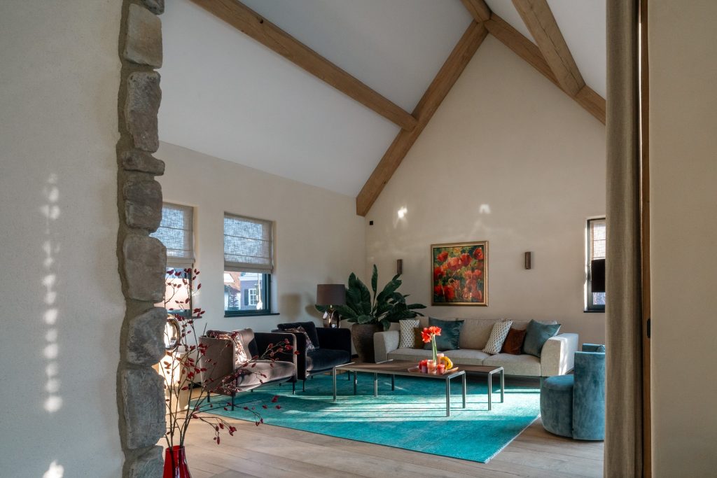 Modern living room with colourful carpet and painting.
