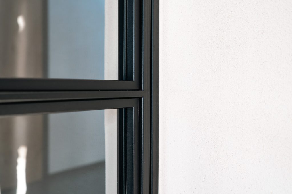 Close-up of black metal frame window