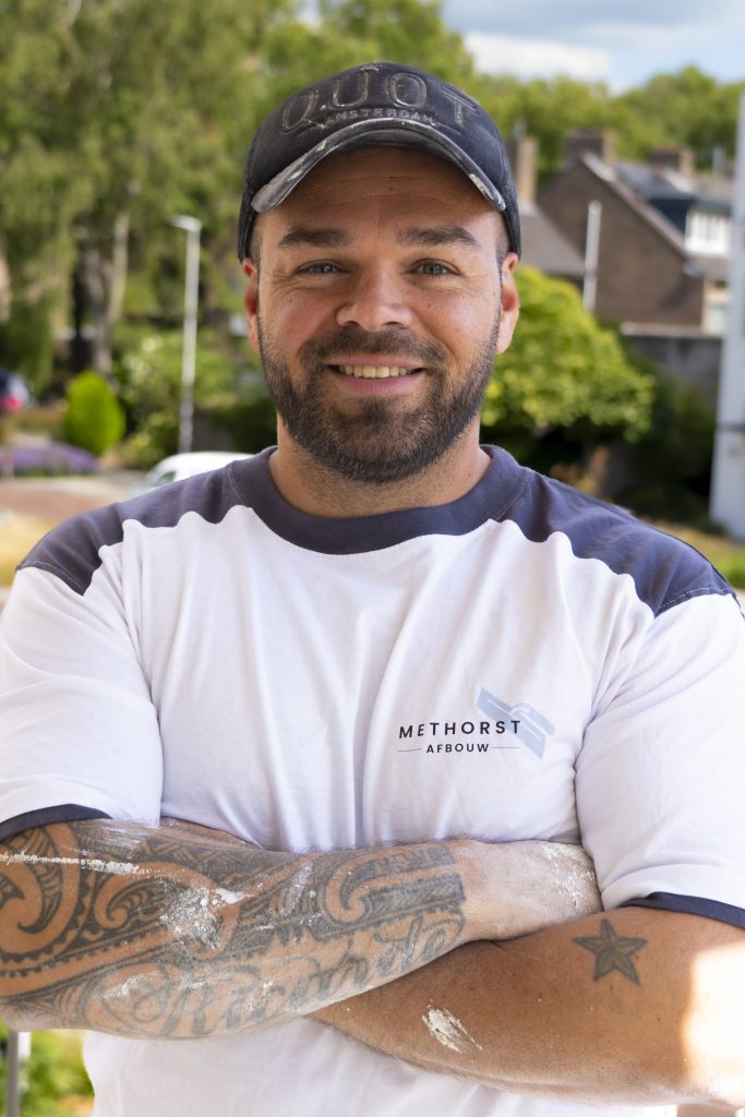 Bouwvakker met tatoeages en pet buiten