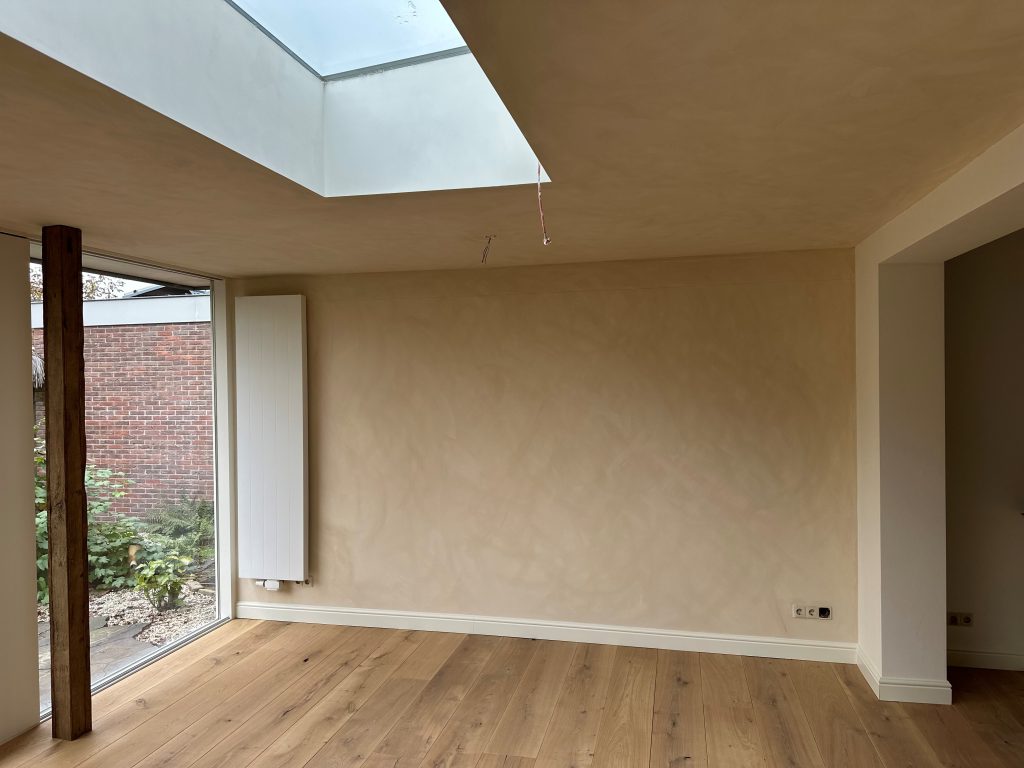 Empty room with large skylight and wooden floor
